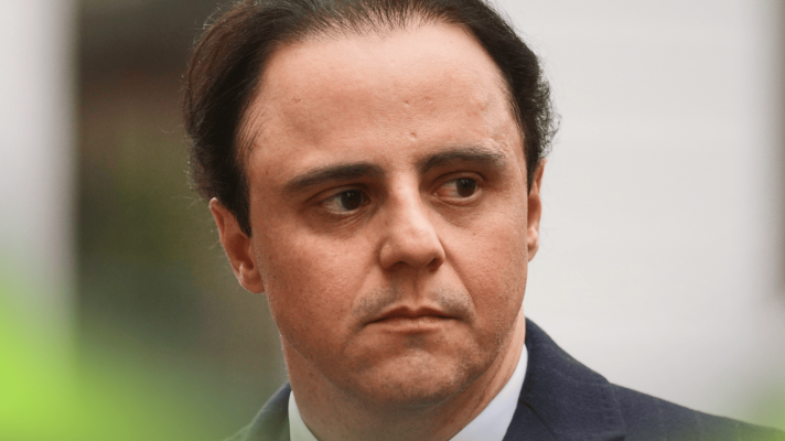 A close-up shot of Felipe Massa wearing a suit as he leaves court in London