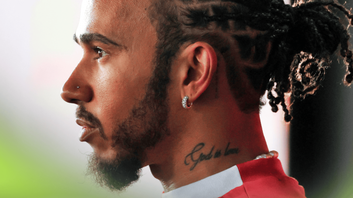 A side-profile shot of Lewis Hamilton wearing Ferrari team kit
