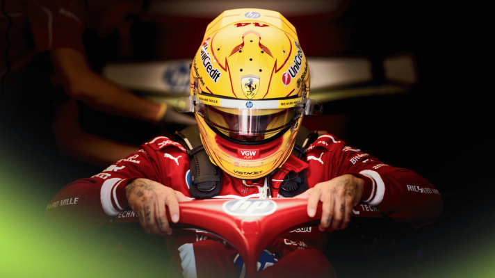 A dramatic shot of Lewis Hamilton lowering himself into the cockpit of the SF-25 car in the Ferrari garage