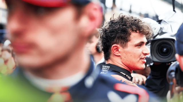 Lando Norris chats in parc ferme with Max Verstappen looming large in the foreground