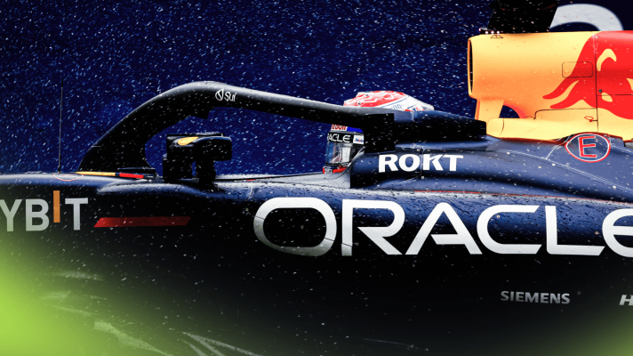 A side-profile shot of Max Verstappen's RB20 as rain falls at Interlagos