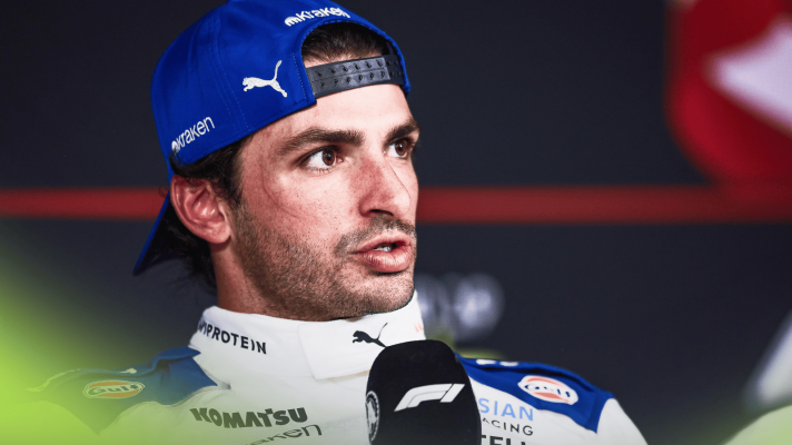 Carlos Sainz speaks in a press conference in his Williams race overalls