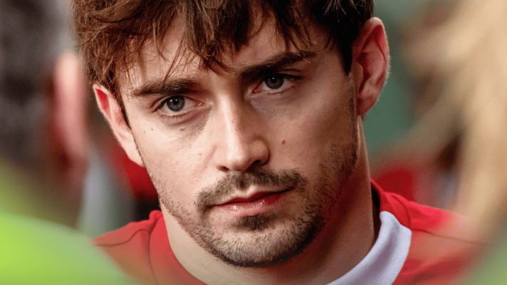 A close-up shot of Charles Leclerc facing the media