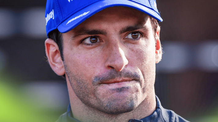 A close-up shot of Carlos Sainz looking into the distance