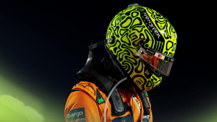 Lando Norris with his helmet on ahead of the start in Qatar with a dark night sky in the background