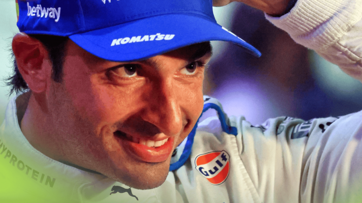 A close-up shot of Carlos Sainz smiling after finishing on the podium in Qatar