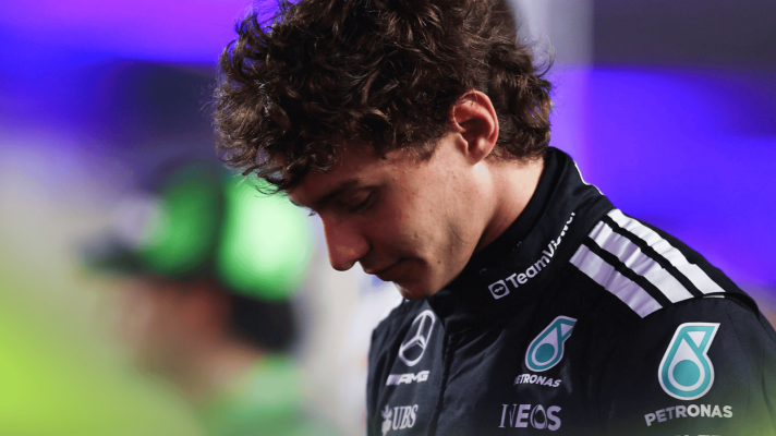 Andrea Kimi Antonelli stands with his head lowered