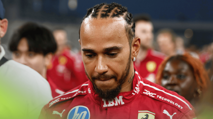 Lewis Hamilton bites his lip as he looks down in Abu Dhabi