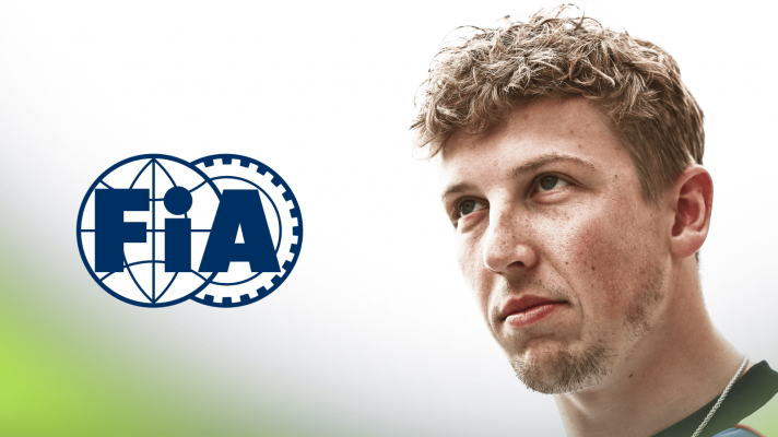 Liam Lawson looks on with a prominent FIA logo alongside him