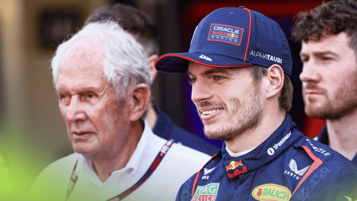 Max Verstappen smiles during a Red Bull photocall with Helmut Marko looking on un the background