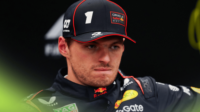 Max Verstappen bites his lip in a press conference