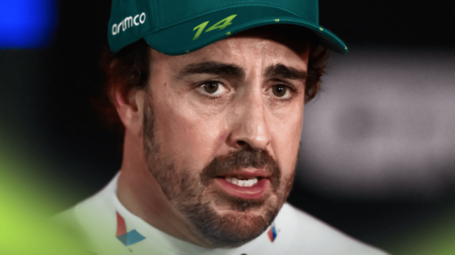 A close-up shot of Fernando Alonso speaking to the media