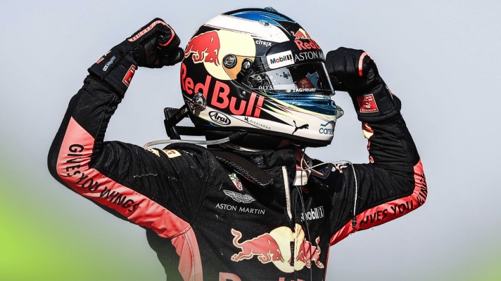 Daniel Ricciardo flexes his muscles in celebration during his Red Bull career