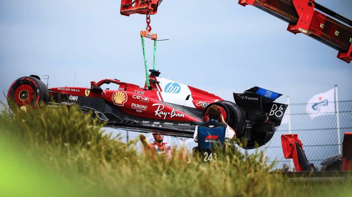 The Ferrari SF-25 of Charles Leclerc hangs from a crane