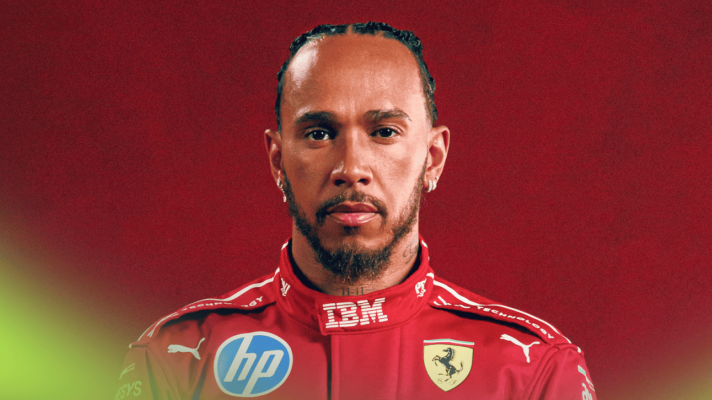 A portrait of Lewis Hamilton wearing Ferrari overalls against a red background