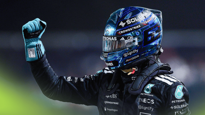 George Russell punches the air in celebration in parc ferme in Singapore