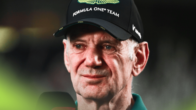 A close up shot of Adrian Newey being interviewed while wearing an Aston Martin cap