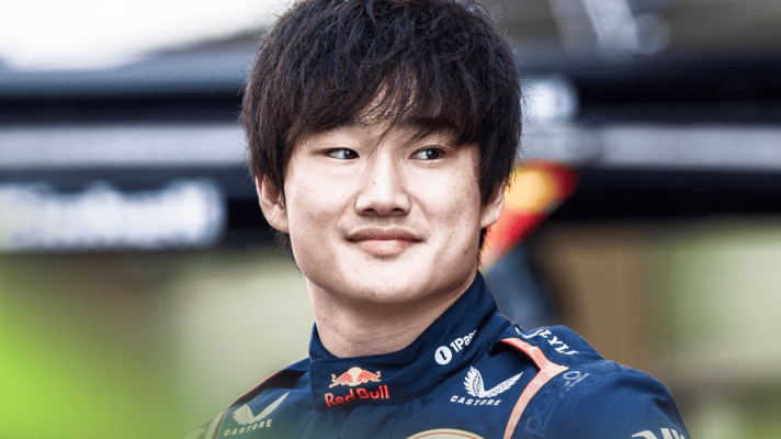 Yuki Tsunoda smiles during an end-of-season Red Bull photocall