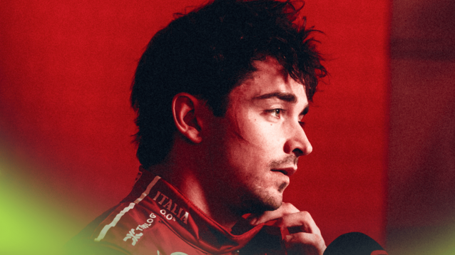 Charles Leclerc adjusts his collar as he faces the media
