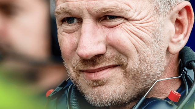 A close-up shot of Christian Horner looking uneasy with a set of headphones on his shoulders