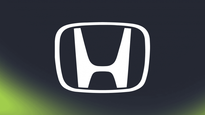 A large Honda logo against a dark background