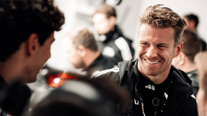 Nico Hulkenberg smiling broadly in the garage during the Audi shakedown in Barcelona