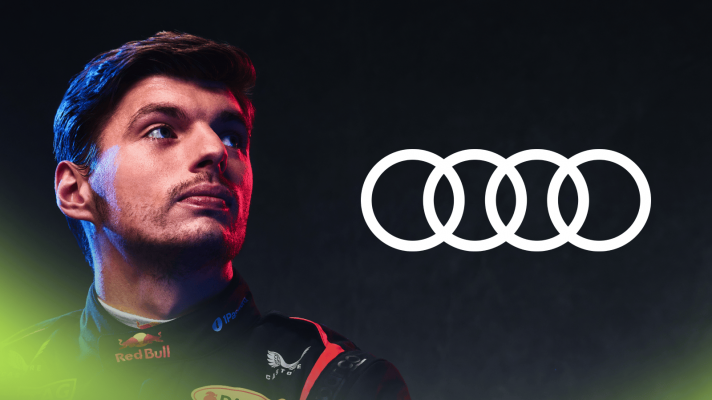 A studio shot of Max Verstappen glancing over his shoulder where a prominent Audi logo sits alongside him