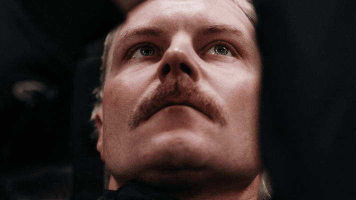 A close-up shot of Valtteri Bottas looking intense during his Cadillac F1 seat fit