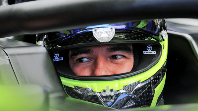 Sergio Perez's eyes visible through his open visor during the Cadillac shakedown