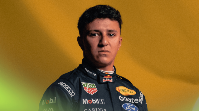 A portrait shot of Isack Hadjar in Red Bull overalls