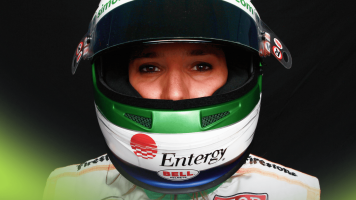 Simona de Silvestro's eyes are visible through the open visor of her helmet in a 2012 IndyCar portrait shot