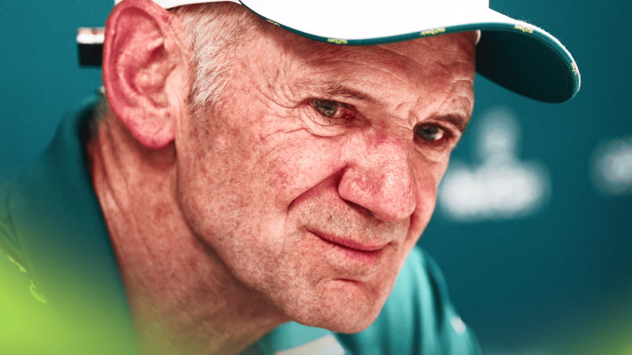 A close-up shot of Adrian Newey grinning thinly