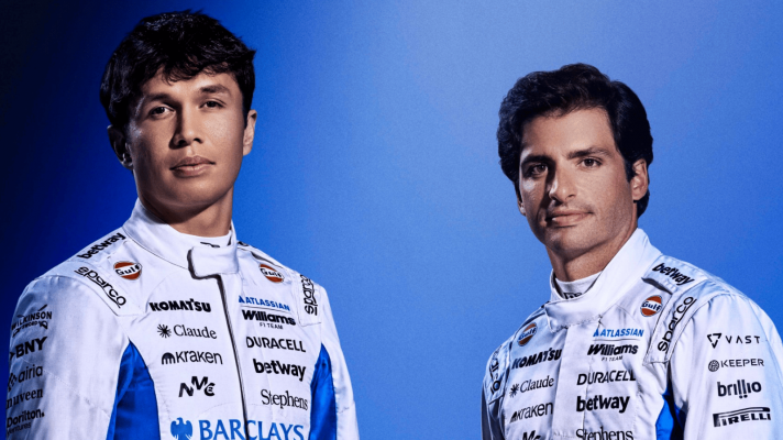 Alex Albon and Carlos Sainz posing together in 2026 Williams race overalls