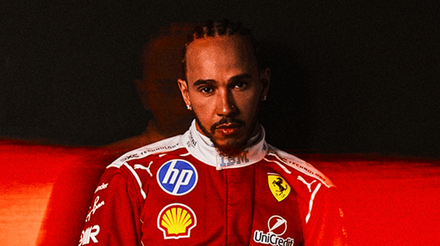 Lewis Hamilton poses in Ferrari 2026 overalls against a dark background