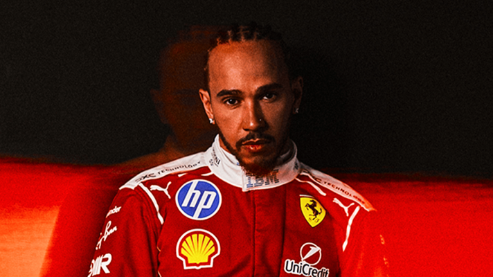 Lewis Hamilton poses in Ferrari 2026 overalls against a dark background