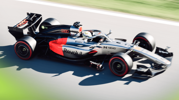 An action shot of Gabriel Bortoleto's Audi on track in a sunny Barcelona