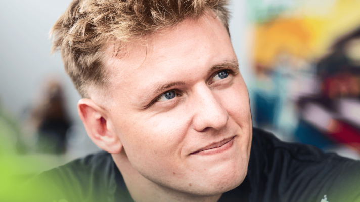 A close-up shot of Mick Schumacher glancing up