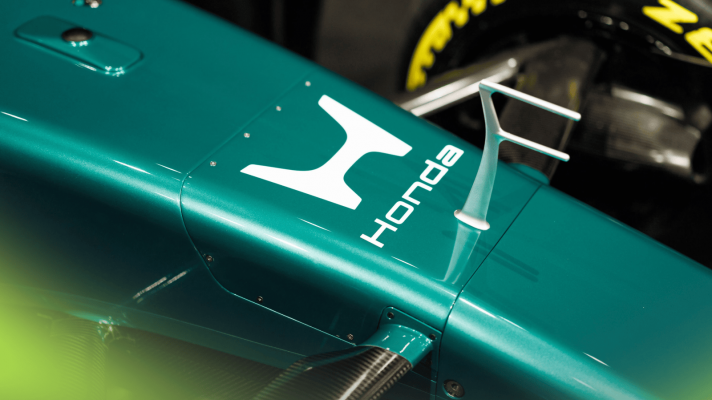 A prominent Honda logo on the nose of a green F1 showcar