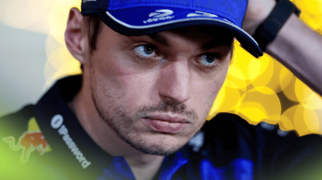 A close-up shot of Max Verstappen looking on as he faces the media