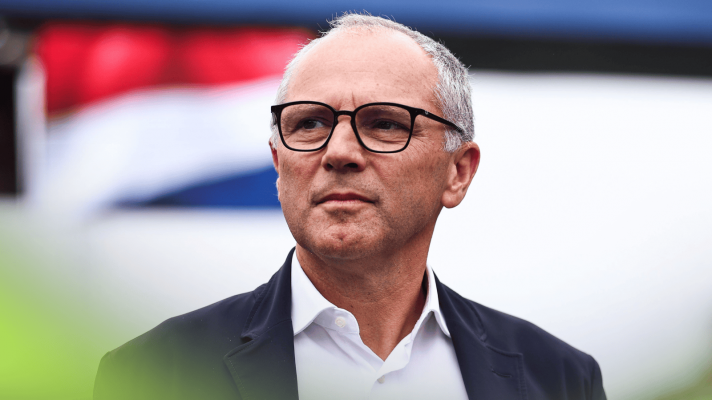 Stefano Domenicali looks on while on the grid at Zandvoort with a Dutch flag in the background