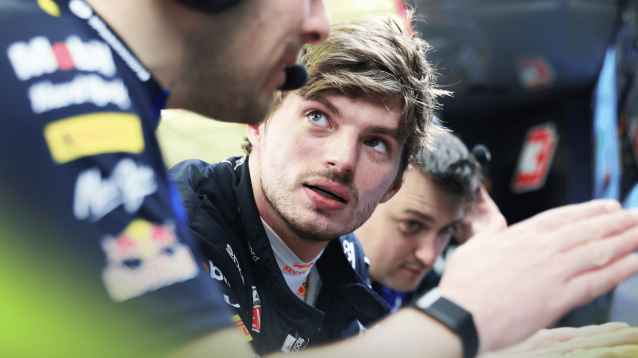 Max Verstappen in conversation with engineers in the Red Bull garage