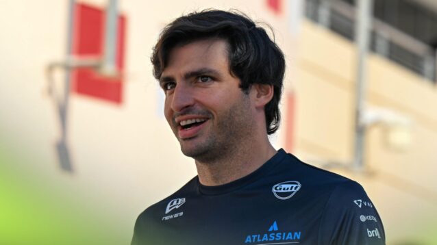 Carlos Sainz walks through the paddock in Bahrain.