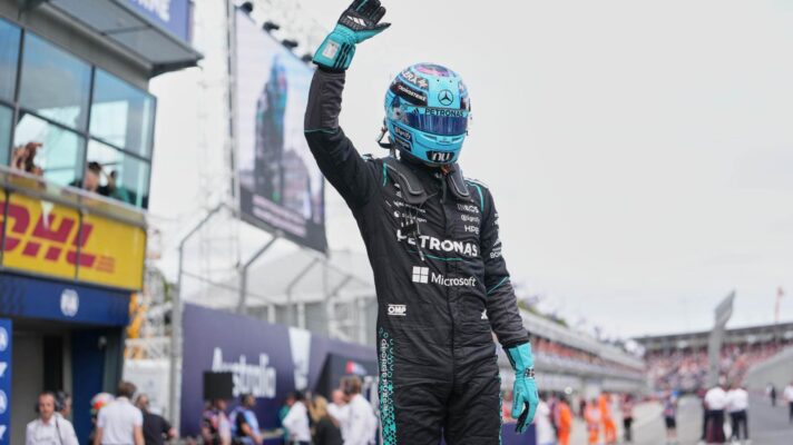 George Russell salutes the fans after taking pole in Melbourne.
