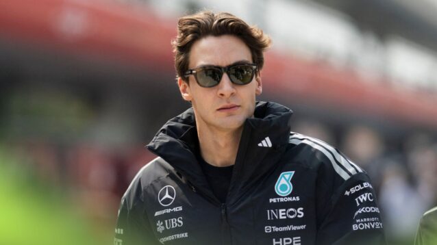 George Russell walks through the paddock in Shanghai.