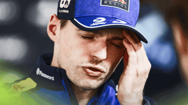 Max Verstappen closes his eyes as he holds his hand to his head