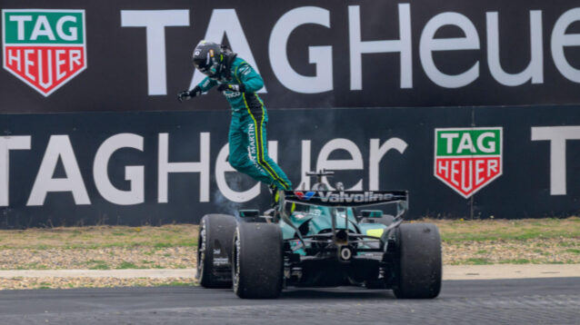 Lance Stroll jumps out of his stricken Aston Martin