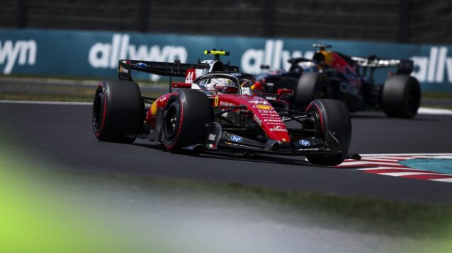 Lewis Hamilton on track at Suzuka with Max Verstappen in the distance behind him.