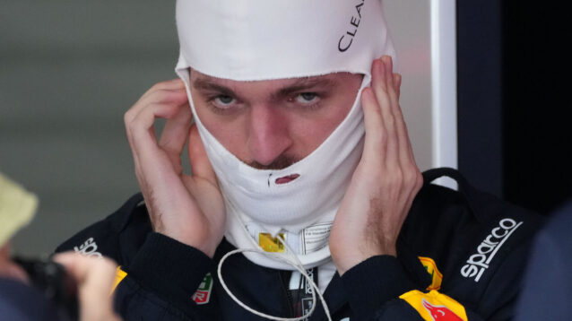 Max Verstappen in the Red Bull garage putting on his fireproofs