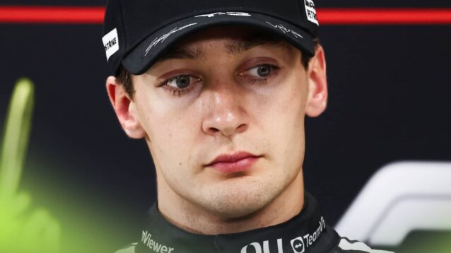 A close-up shot of George Russell in a press conference
