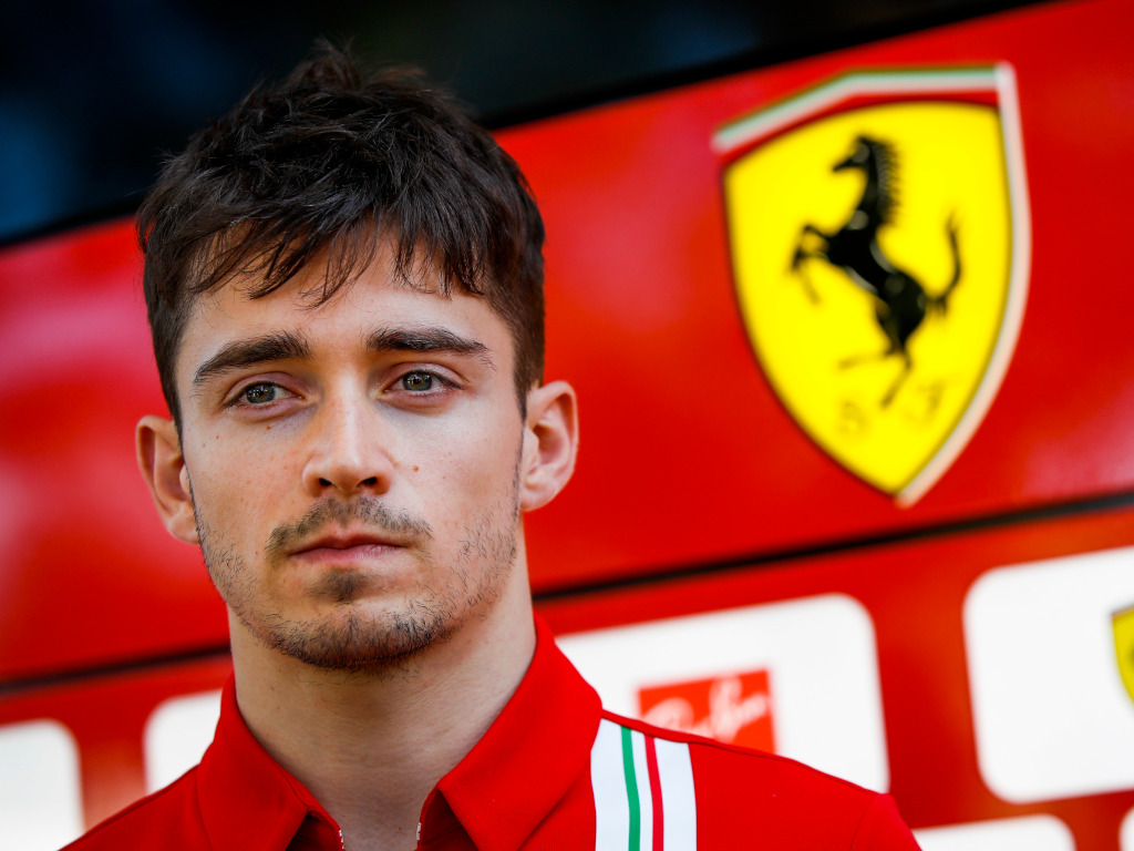 Charles Leclerc Ferrari logo in the background pa